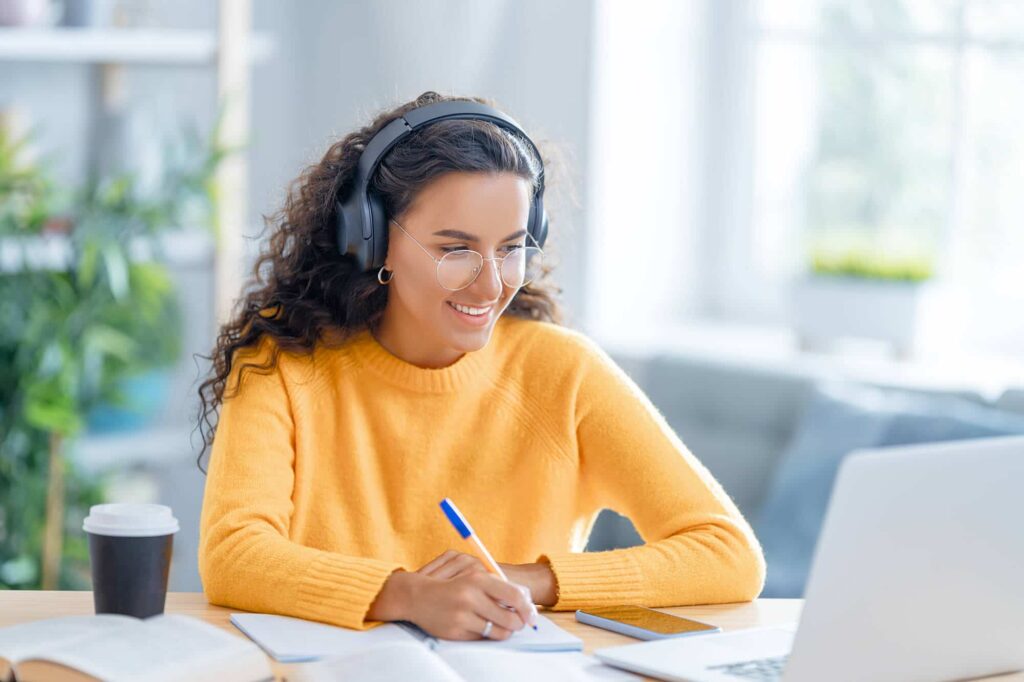 Student attending an online GCSE tutoring session and completing coursework